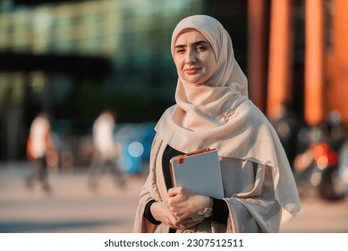 Portrait of a Muslim business woman in the city street near the office building. - Powered by Shutterstock