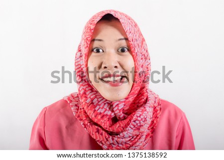 Portrait of muslim business woman smiling girl, posing at white studio background. Young emotional woman. The human emotions, facial expression concept. Front view