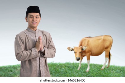 Portrait Of Muslim Man With Cow For Idul Adha Qurban Celebration