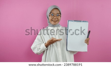 portrait of a Muslim woman becoming a teacher on a pink background