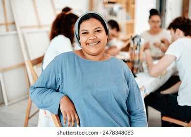 Portrait, Muslim woman and happy for paint and creativity in workshop with watercolor and friends. Artist, hijab and smile for painting in creative studio with canvas, acrylic and group art therapy - Powered by Shutterstock