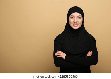 Portrait of Muslim woman in hijab on beige background, space for text - Powered by Shutterstock