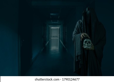 Portrait of a mysterious black man holding a skull in his hand at a creepy hotel corridor
 - Powered by Shutterstock