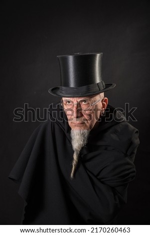 Similar – Man in tails with bouquet and top hat looks into camera