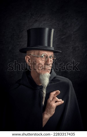 Man in tails with bouquet and top hat looks into camera