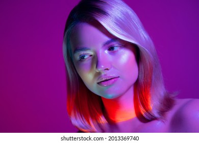 Portrait and neon  style lighting  young beautiful blonde woman and gradient multicolored light her face 