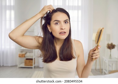 Portrait Of Nervous Woman In 20s 30s Looking At Reflection In Bedroom Or Bathroom Mirror With Upset Frustrated Expression Seeing Sign Of Alopecia Hairloss Problem Or Scalp Dandruff After Wrong Shampoo