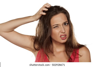 Portrait Of Nervous Young Woman With Itching In Her Hair