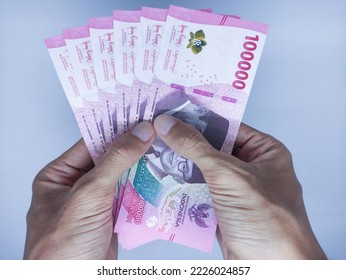 A portrait of new banknotes for Rp.100,000 issued in 2022 on isolated white background. Indonesian rupiah currency.