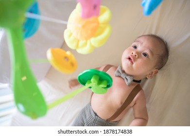 Portrait Of New Born Baby Laying Down On The Bed