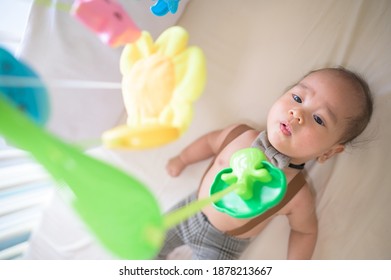 Portrait Of New Born Baby Laying Down On The Bed