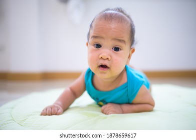 Portrait Of New Born Baby Laying Down On The Bed