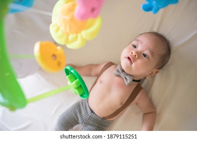 Portrait Of New Born Baby Laying Down On The Bed