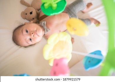 Portrait Of New Born Baby Laying Down On The Bed