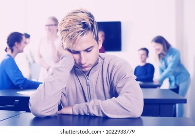 Portrait New Boy Student Being Shy Among Classmates At Recess In School