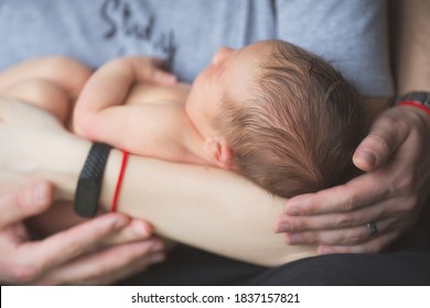Portrait of a newborn boy 2 weeks old in the hands of his parents. Pregnancy, motherhood, preparation and expectation of motherhood, the concept of child birth. Happy family and family values.