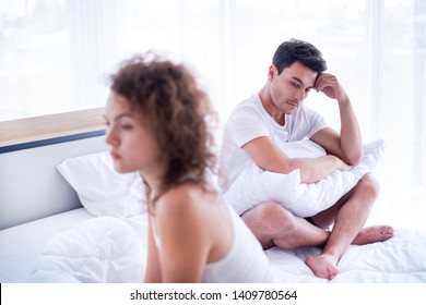 Portrait of newlywed have a fight in bed. The couple having difficulties in relationship. Wife always sulking & husband get angry easily. He has problem with erection too. Domestic violence concept. 