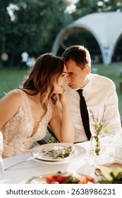 portrait of the newlyweds at the presidium at the wedding banquet