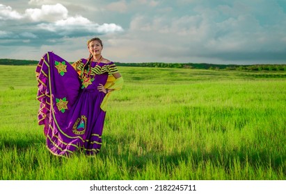 Portrait of Nicaraguan young woman in traditional folk costume in the field, Nicaraguan woman in traditional folk costume in the field grass