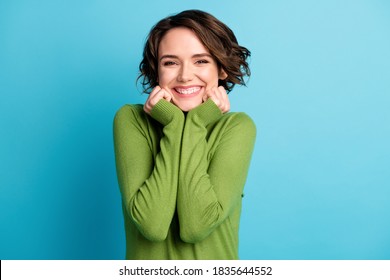 Portrait Of Nice Attractive Charming Girl Touch Hands Face Enjoy Weekend, Wear Green Style Stylish Trendy Clothes Isolated Over Blue Color Background