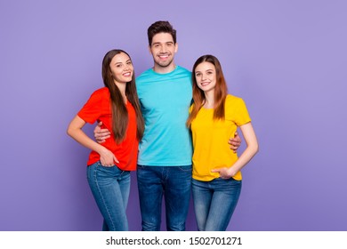 Portrait of nice attractive lovely charming cute cheerful cheery content friendly guys wearing colorful t-shirts jeans denim gathering spending free time isolated over violet lilac background