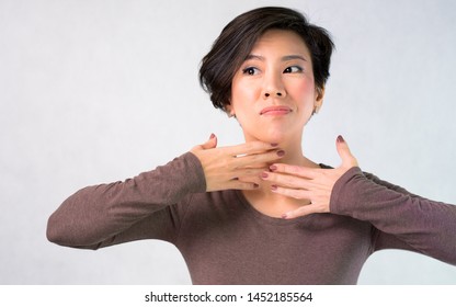 Portrait Of Nice Charming Attractive Middle Aged Asian Woman Worried  About Aging Neck Wrinkles, She Cover With Her Hands. Anti-aging, Face Self-massage, Beauty Skin Care, Signs Of Aging Concept.