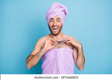Portrait of nice cheerful guy wear turban towel cutting unwanted hair on chest torso isolated on bright blue color background
