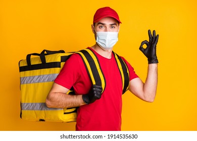 Portrait Of Nice Content Healthy Guy Mailman Wear Gauze Mask Carrying Bag Order Showing Ok-sign Isolated On Bright Yellow Color Background