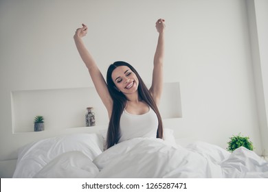 Portrait of nice cute attractive sweet lovely winsome fascinating fresh lady sitting on bed raising hands up in light white interior room - Shutterstock ID 1265287471