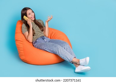 Portrait Of Nice Cute Lovely Girl With Straight Hair Dressed Striped T-shirt Talking Speaking Smartphone Isolated On Blue Color Background