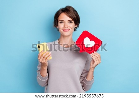 Portrait of nice cute pretty girl brown hair dressed gray pullover telegram instagram twitter facebook isolated on blue color background