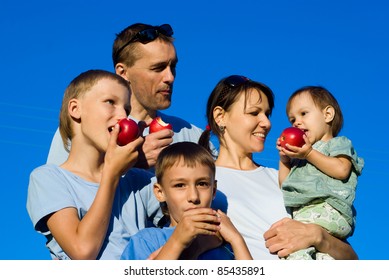 portrait of a nice family eating apples - Shutterstock ID 85435891