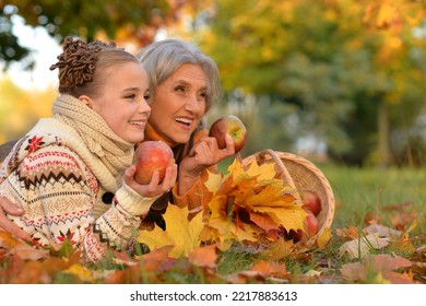 Portrait of nice grandmother of their granddaughter in autumn - Powered by Shutterstock