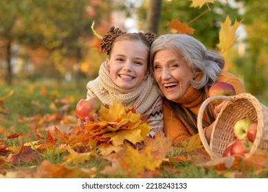 Portrait of nice grandmother of their granddaughter in autumn - Powered by Shutterstock