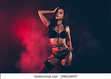 Portrait Of Nice Lovable Stunning Gorgeous Charming Adorable Attractive Sporty Wavy-haired Lady Wearing Swordbelt Posing Teasing Touching Hair Isolated Over Black Red Light Background