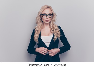 Portrait of nice lovely alluring gorgeous attractive cheerful wavy-haired lady eyeglasses eyewear manager teacher tutor university fixing button isolated over gray pastel background