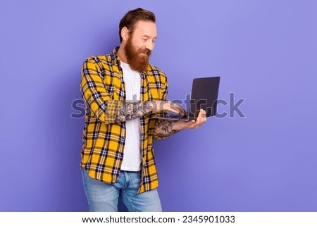 Portrait of nice man use wireless netbook microsoft apple empty space ad isolated on purple color background