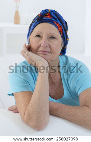 Portrait of a nice senior woman recovering after chemotherapy - focus on her smiling relax attitude