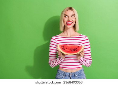 Portrait of nice starving girl with short hair dressed striped clothes look empty space hold watermelon isolated on green color background - Powered by Shutterstock