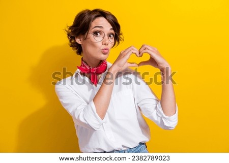 Portrait of nice sweet person pouted lips kiss arms show heart symbol isolated on yellow color background