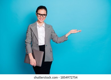 Portrait Of Nice Trendy Cheerful Girl Employee Carrying Laptop Holding On Palm Copy Space Place Advert Isolated Bright Blue Color Background