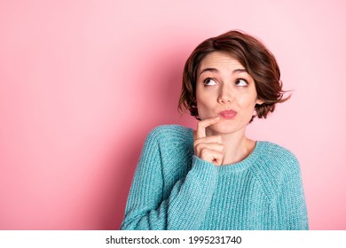 Portrait of nice unsure curly brunette hairdo lady finger face look empty space wear blue sweater isolated on pastel pink color background