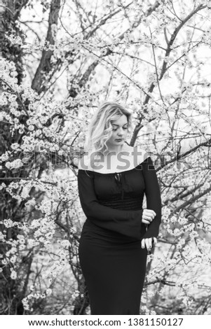 Portrait of nice woman at chiffon dress in garden, tenderness and femininity concept