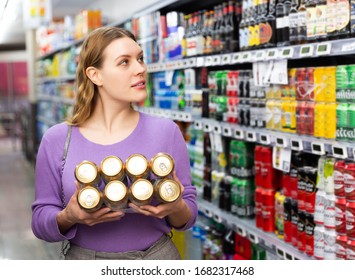 Portrait Of Nice Woman Customer Buying Can Beer In Hypermarket
