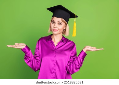 Portrait of nice young lady mortarboard hat hold empty space vs wear violet shirt isolated on green color background - Powered by Shutterstock