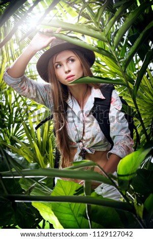 portrait of nice young woman  exploring jungle environment