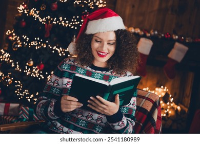 Portrait of nice young woman read book wear sweater new year xmas garland lights flat indoors - Powered by Shutterstock