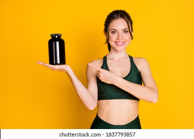 Portrait of nice-looking cheerful girl holding on palm demonstrating pills product isolated over bright yellow color background - Powered by Shutterstock