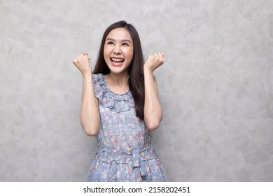 Portrait Of Non-binary Young With Long Hair Asian Woman In Flower Dress And Cool Style With Calm Attitude In Studio