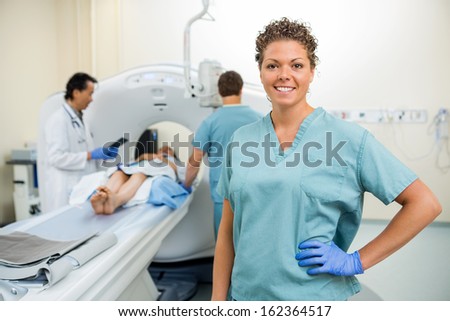 Portrait of nurse with colleague and doctor preparing patient for CT scan in hospital